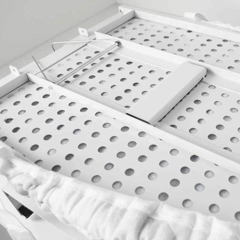 Perforated metal support frame under ironing board